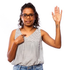 A First Nations woman pointing at herself. 