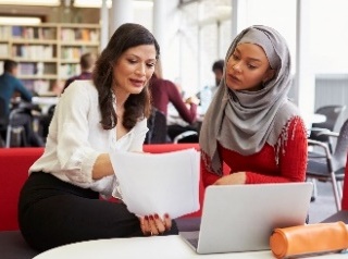 Two women studying together. 