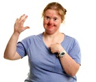 A woman pointing at herself. 