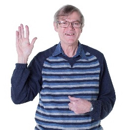 An older man pointing at himself.