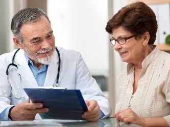 A doctor showing a woman information. 